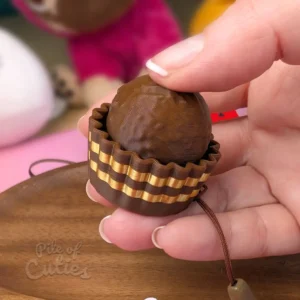3D printed chocolate praline clicker keychain with textured surface