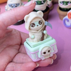 3D printed cute Grim Reaper clicker desk toy standing upright